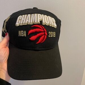 New Era Raptors Black Cap with Gold 'CHAMPIONS' and Red Basketball Logo